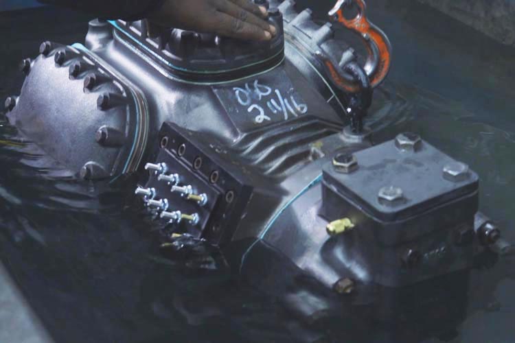 City Compressor - partially submerged compressor undergoing leak test